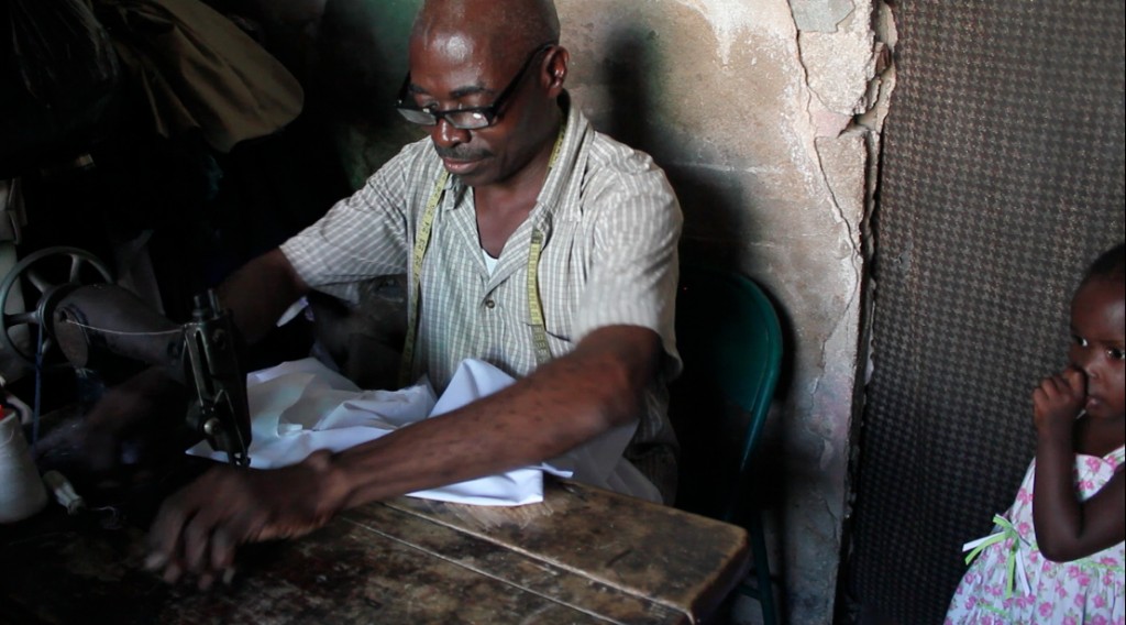 Daomed Daniel, a Haitian tailor in Cité Soleil, can no longer find full-time work because of the unregulated dumping of used clothing, which he says is "invading the country." Photo by Isabeau Doucet 